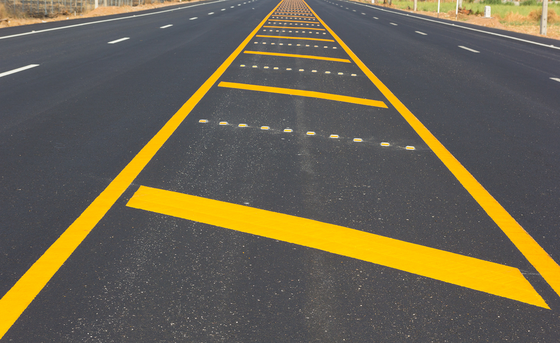 Empty highway with yellow road markings