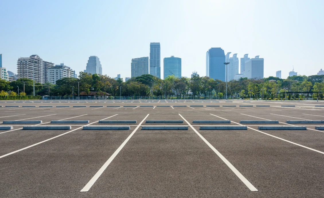 Empty parking lot with city skyline